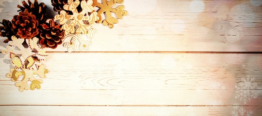 Naklejka na ściany i meble Snowflakes and pine cone on wooden plank
