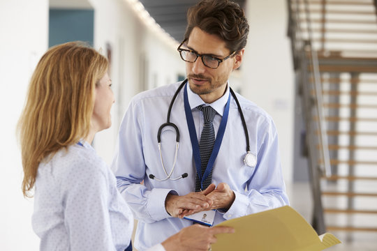 Young Male And Female Doctors Consulting Each Other