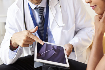 Two senior doctors using tablet computer, mid section - Powered by Adobe