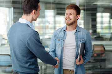 Cheerful partners shaking their hands
