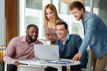 Serious blonde woman looking at laptop