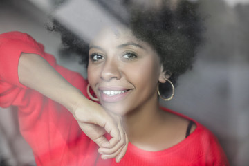 Portrait of a beautiful young girl in front of a window