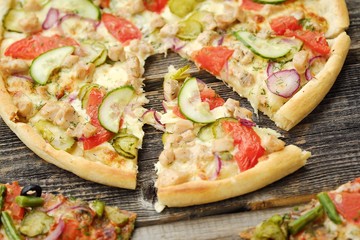 Delicious pizza with chicken cheese and vegetables