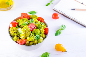 Top view Salad Bowl with cherry tomatoes, and broccoli and diet notebook on the white wooden background. Healthy lifestyle concept. Detox, diet, vegitarian. Selective focus. Text space.