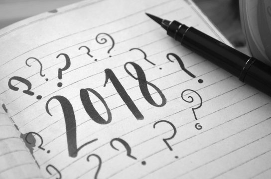 2018 with question marks brush calligraphy in notebook