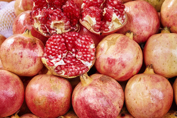 Natural ripe pomegranates on a local market, shallow depth of field.