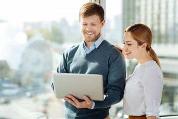 Attentive man demonstrating his laptop