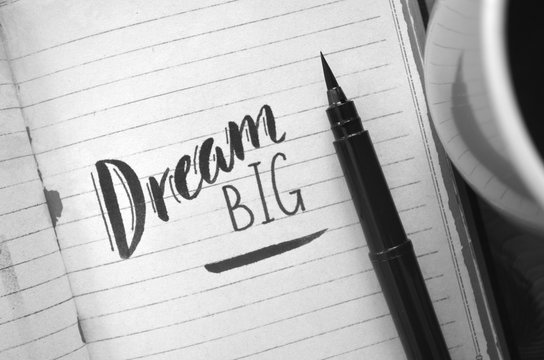 DREAM BIG motivational quote written in notebook