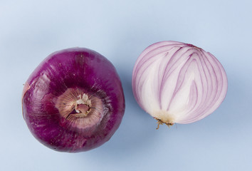 Red onions, top view, on the blue background.