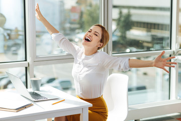 Happy blonde female celebrating her success