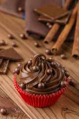 Homemade chocolate cupcake with chocolate chips in red cup