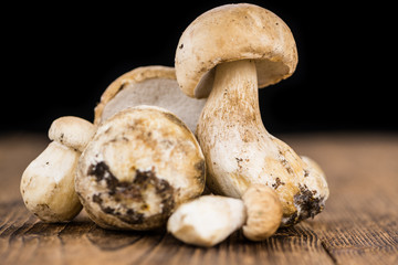 Fresh Porcinis (raw) on a vintage background (close-up shot)