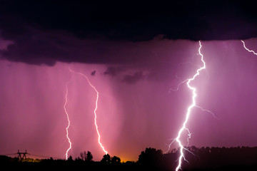 Lightnings and storm over forest at night. Thunder