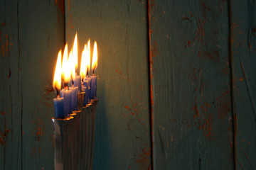 image of jewish holiday Hanukkah background with traditional menorah (traditional candelabra) and burning candles