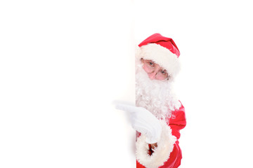 Kind Santa Claus pointing in white blank sign, isolated on white background