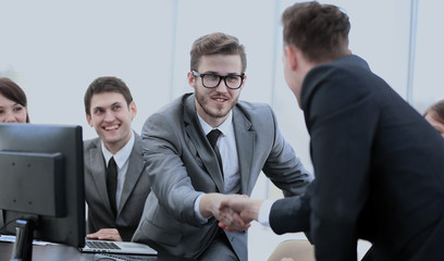 business partners near your Desk to shake hands as a sign of coo