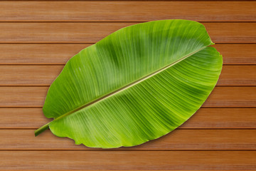 banana leaf on on brown wood background