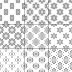 Gray and white floral ornaments. Collection of seamless patterns