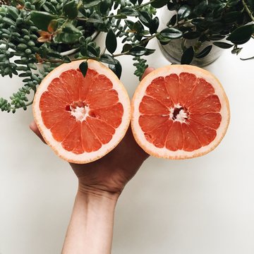 Two grapefruit halves on a white table