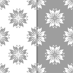 White and gray floral ornamental designs. Set of seamless patterns