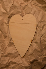 Wooden hearts on crumpled kraft paper