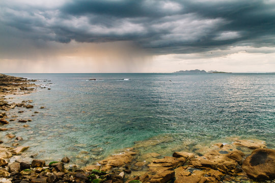 Calm sea under cloudy sky
