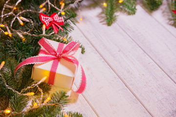 Christmas card. Background on a theme of New Year's  party. Decorated fir-tree with gifts and candles on the background of colorful festive lights. A magical evening.