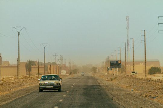 Car driving in desert city