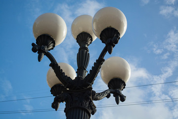 Decorative street lamp and golden autumn  in a city park. Latvia, Riga.