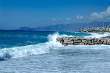 Waves break about a stone pier