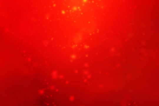 Abstract red lights background. Festive xmas abstract background with bokeh defocused lights and stars. Card or invitation for your design.