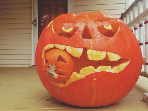 A pumpkin eating another pumpkin