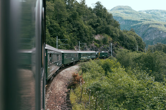 Train riding in green valley