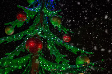 green christmas tree with red balls and snow