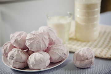 Pink sweets - Zefir (Russian marshmallow) and milk on the table, food concept
