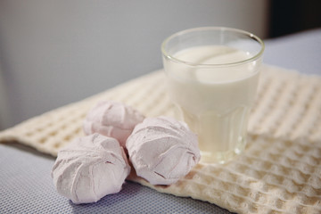 Glass of milk and pink zefir (Russian marshmallow) 