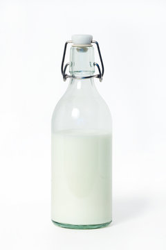 Milk in a glass bottle on a white background