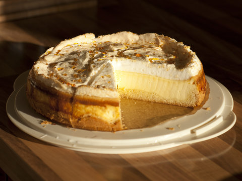 Tasty cake with golden drops on a table