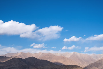 Closeup image of mountains and blue sky with clouds background in Ladakh , India