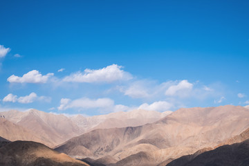 Naklejka na ściany i meble Closeup image of mountains and blue sky with clouds background in Ladakh , India