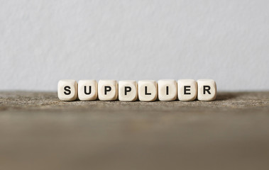 Word SUPPLIER made with wood building blocks