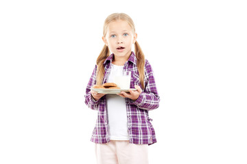 Portrait of little girl holding plate with cookies