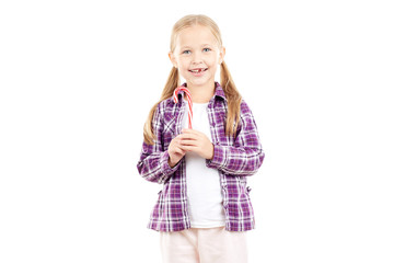 Portrait of cute little girl holding candy cane