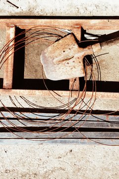 Rusty shovel, ladders and copper wire