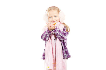 Portrait of little girl wearing scarf and winter ear muffs on white background