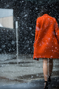Bright orange jacket in the falling snow