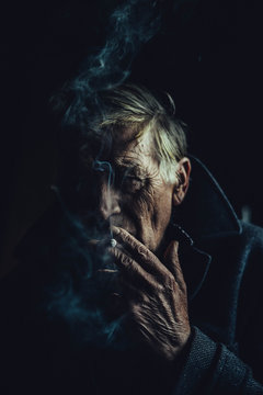 Portrait Of Senior Man Smoking Cigarette