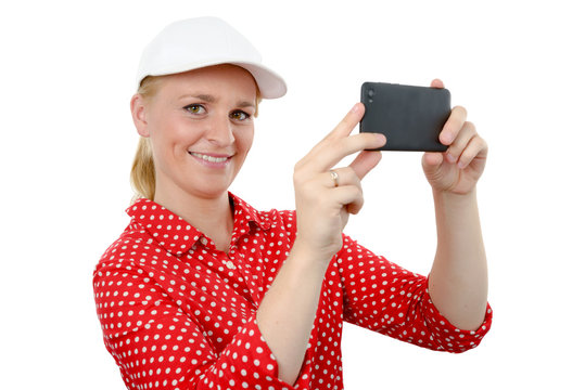 smiling woman taking picture with smartphone camera, on white