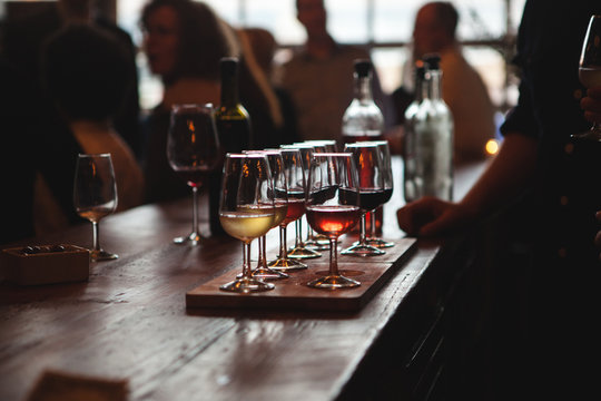Sampler tray of wine sitting on bar at winery