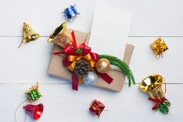 Christmas gift box,paper note and new year decoration on white wood plate.Flat lay.Christmas and New year concept.
